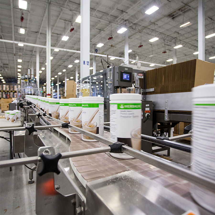 Herbalife factory with F1 shake canisters on the production conveyor belt in the factory