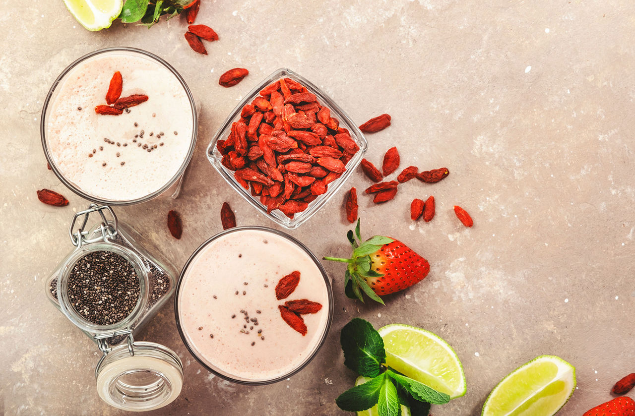 Protein shake with strawberries and goji berries, Healthy blended diet smoothie drink with strawberry and goji berries, chia seeds and lime. Top view