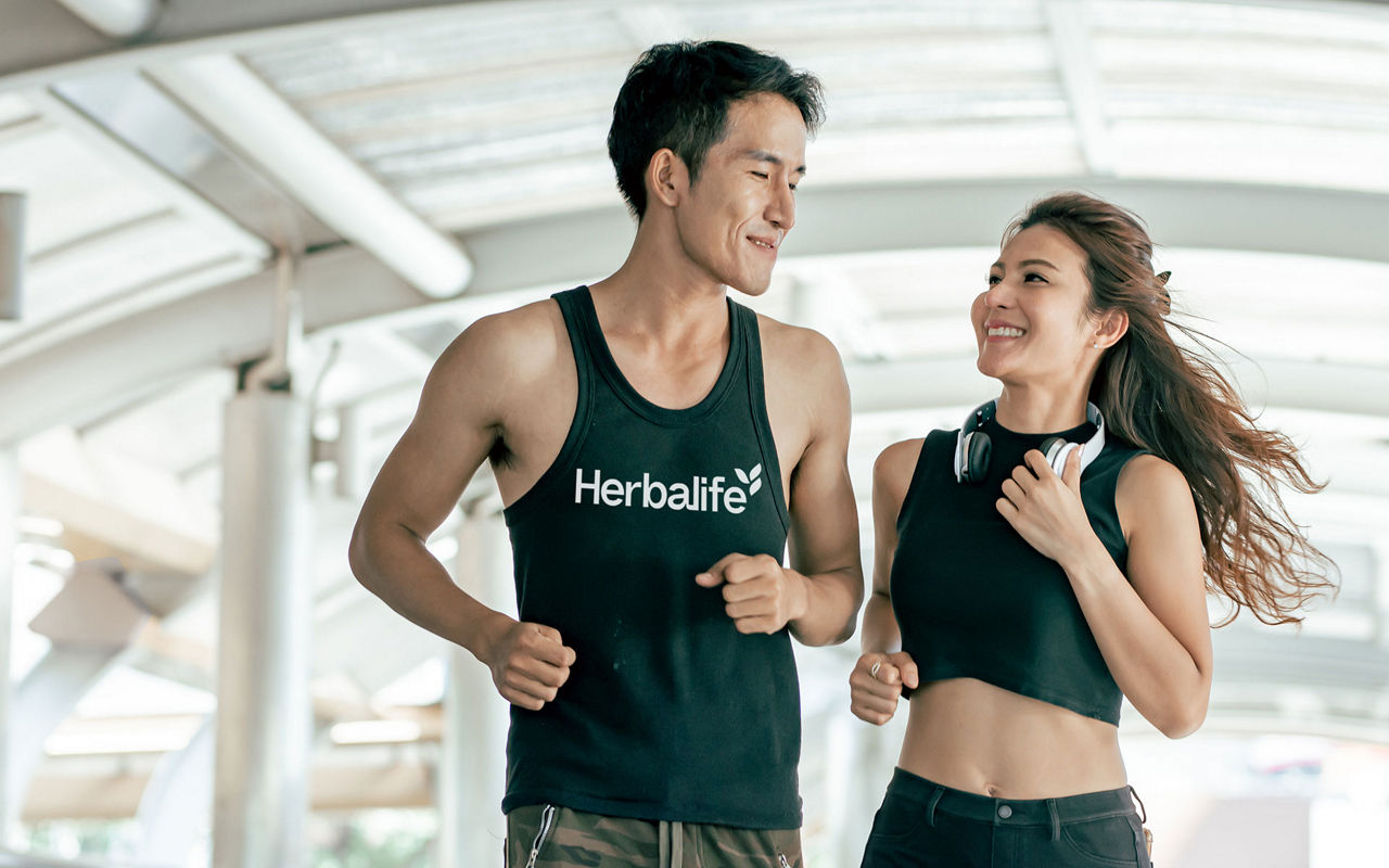 Couple jogging together, Asian Healthy and Sportive couple smiling to each other, running and jogging outdoor. Sport and Lifestyle Concept.