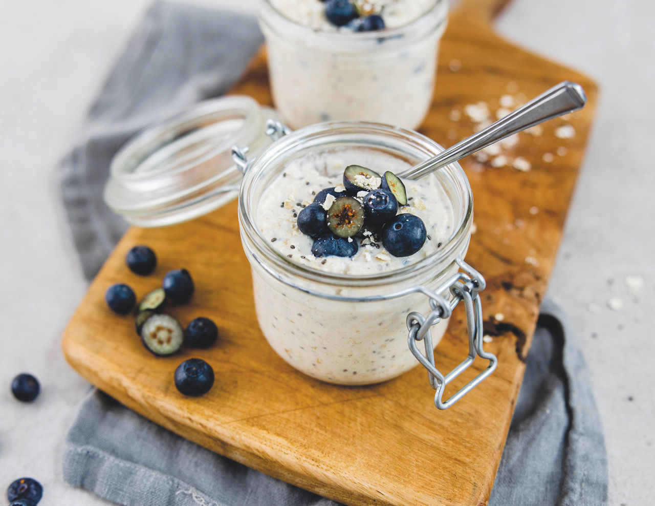 Chia oats in jars topped with fresh blueberries