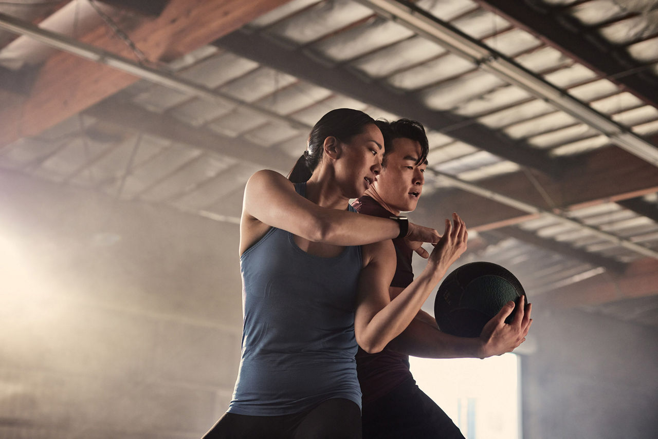 Couple doing spin with medicine ball