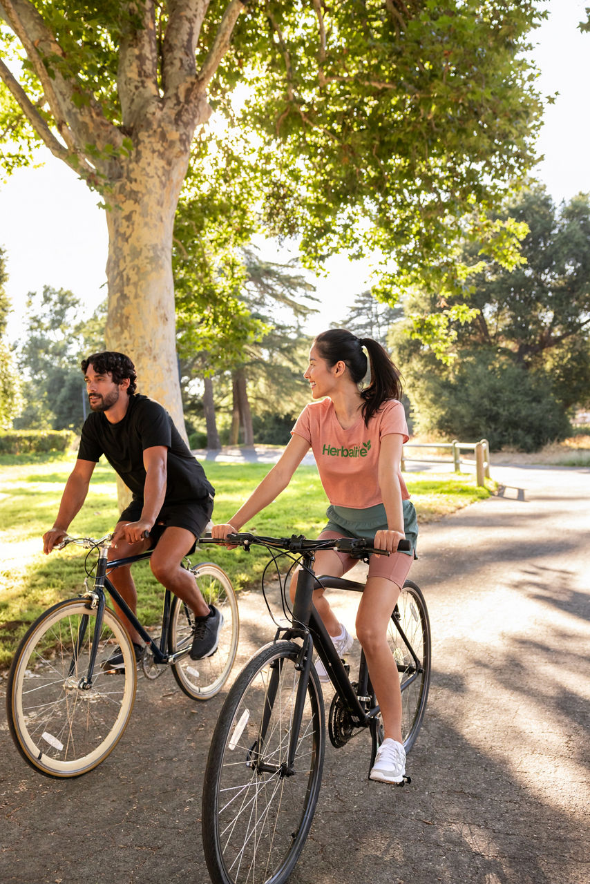 Couple relax by riding bikes.