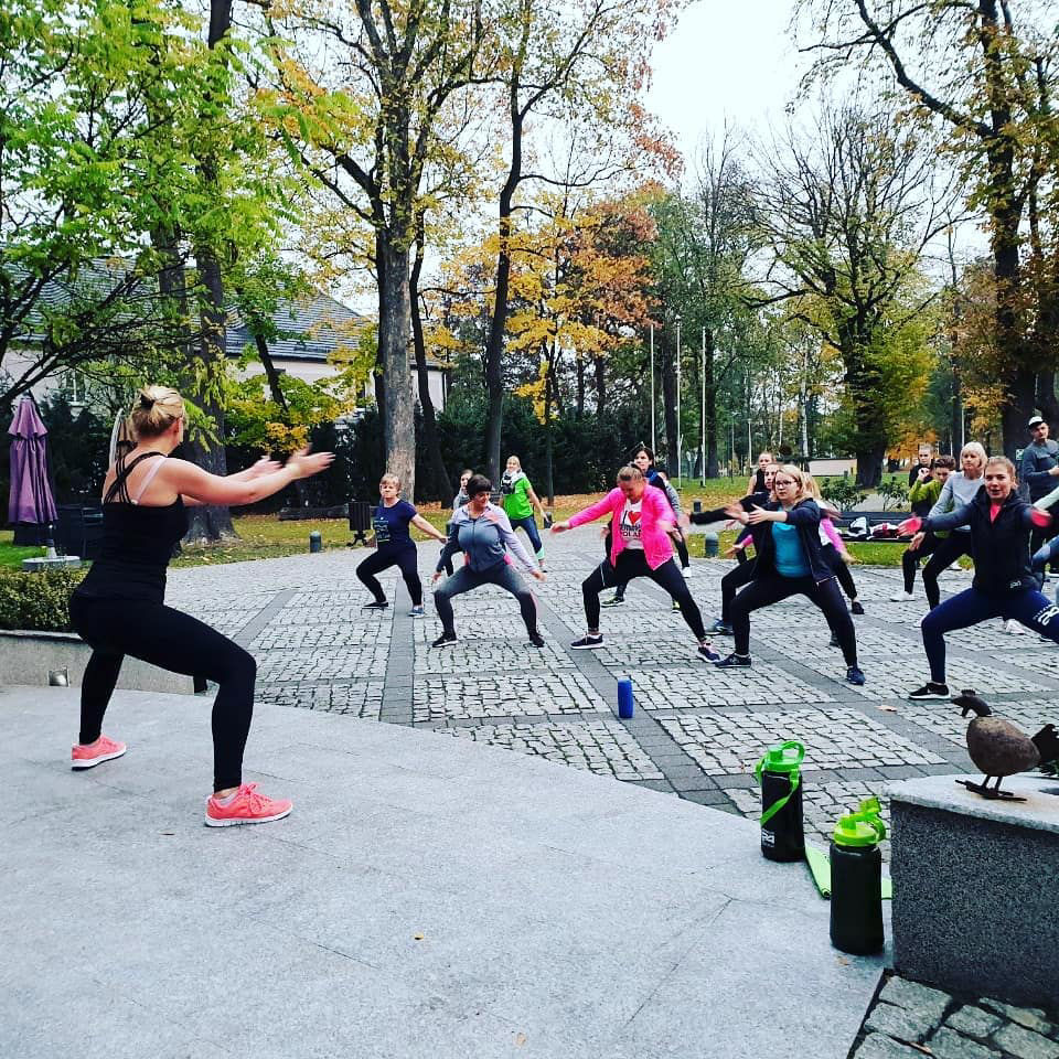 Distributor leading a fitness workout of customers outdoors