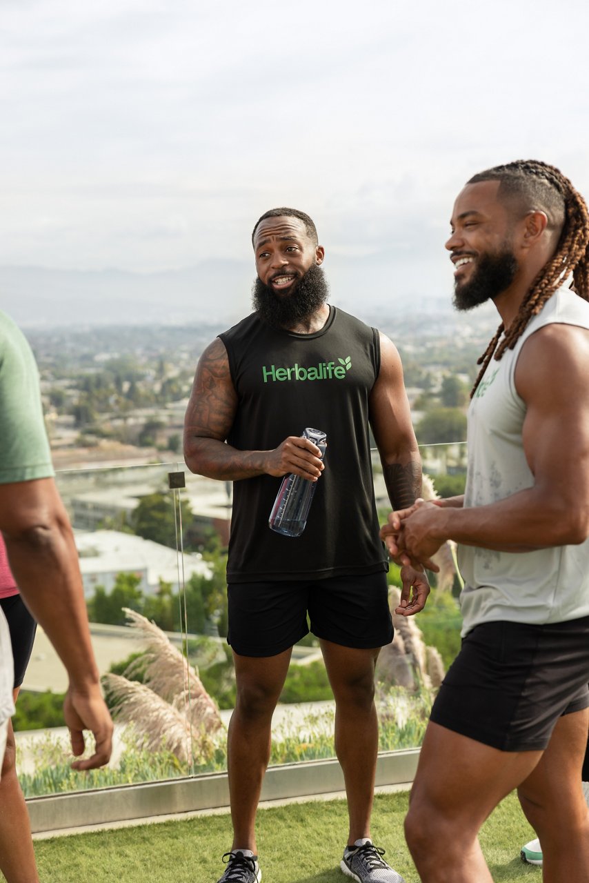 Distributors taking a break after group exercise session with Herbalife products.