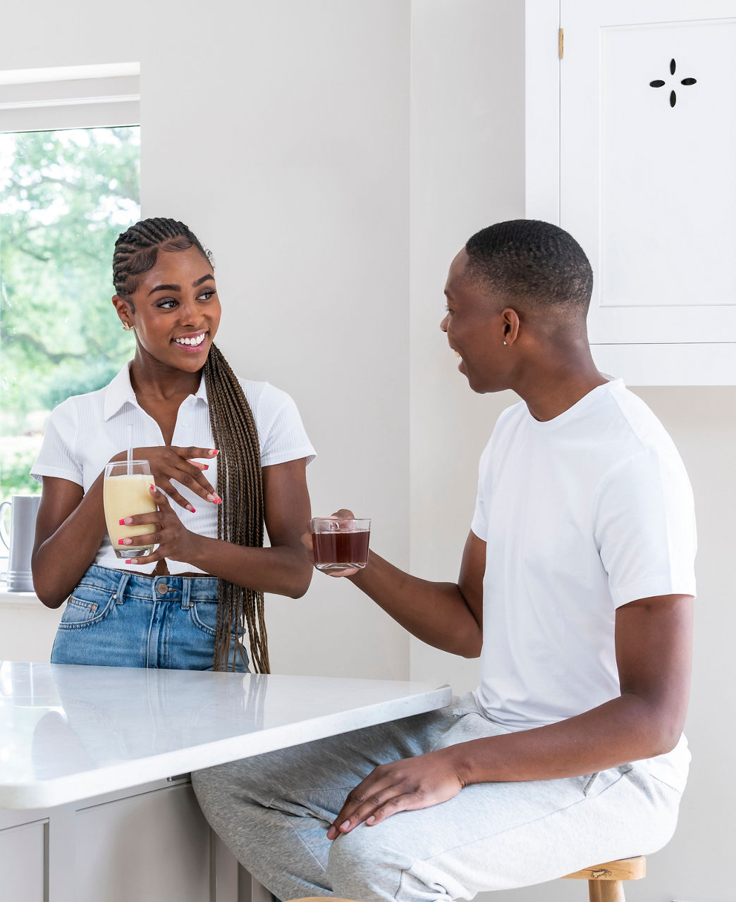 Couple having shake and tea in their kitchen