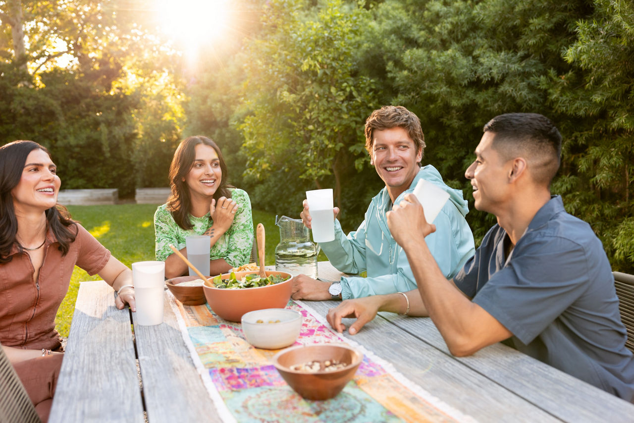 Friends laughing and relaxing during a picnic