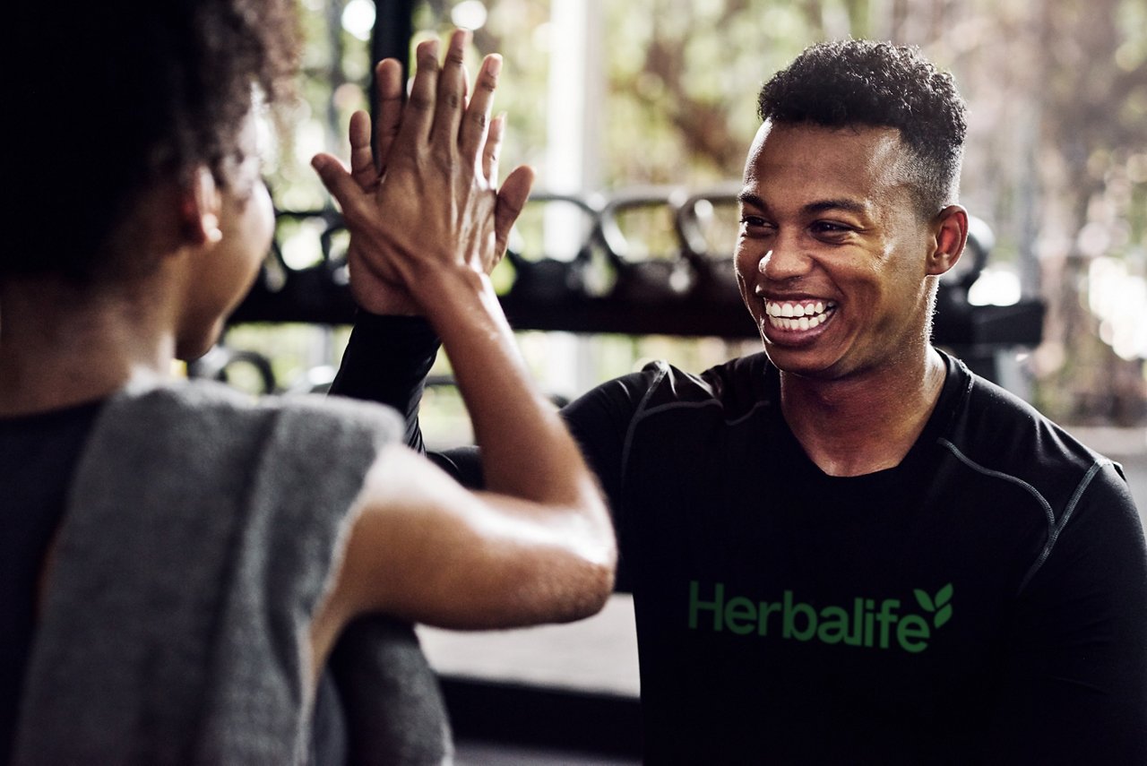 Friends high-fiving in the gym, Friends high fiving at the gym