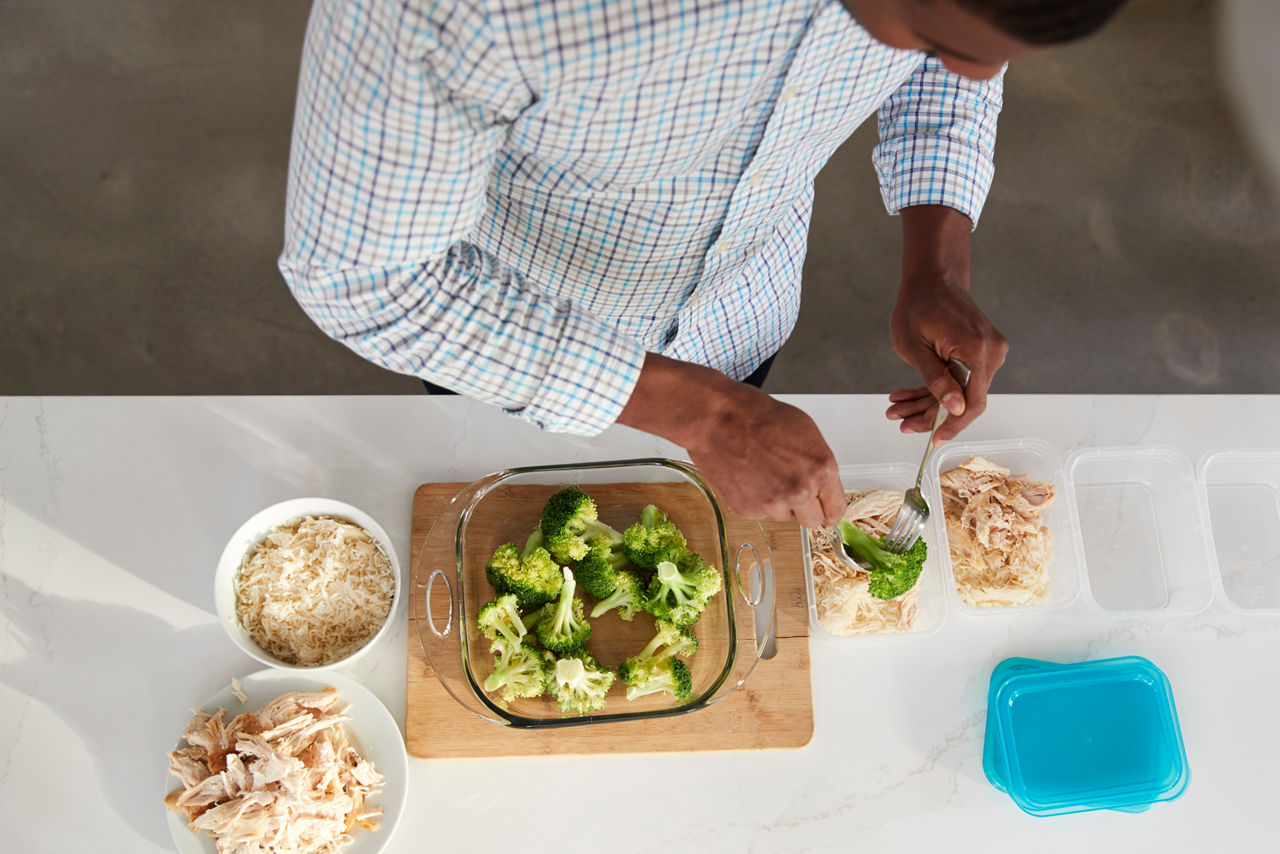 Man in kitchen preparing a high protein meal