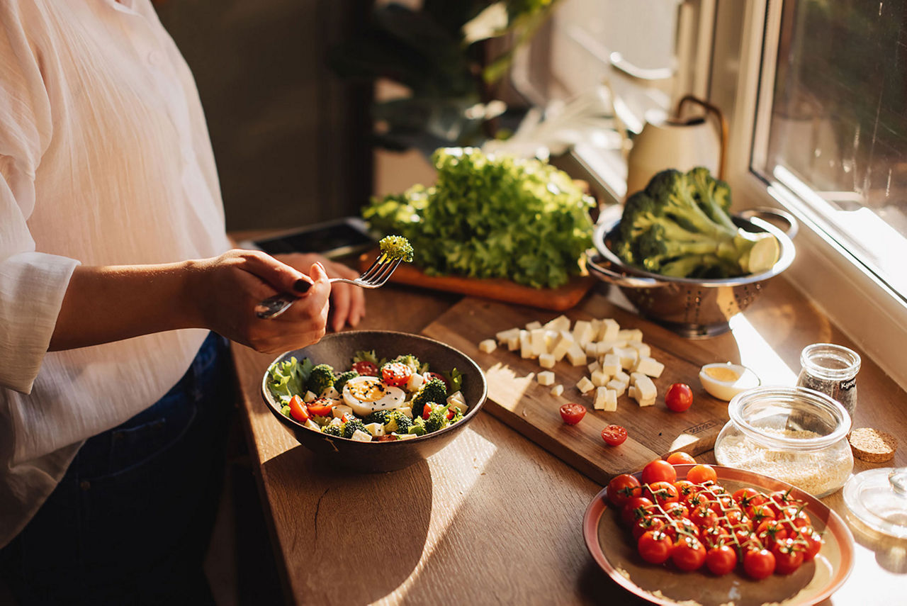 Woman makes a healthy salad for a balanced diet