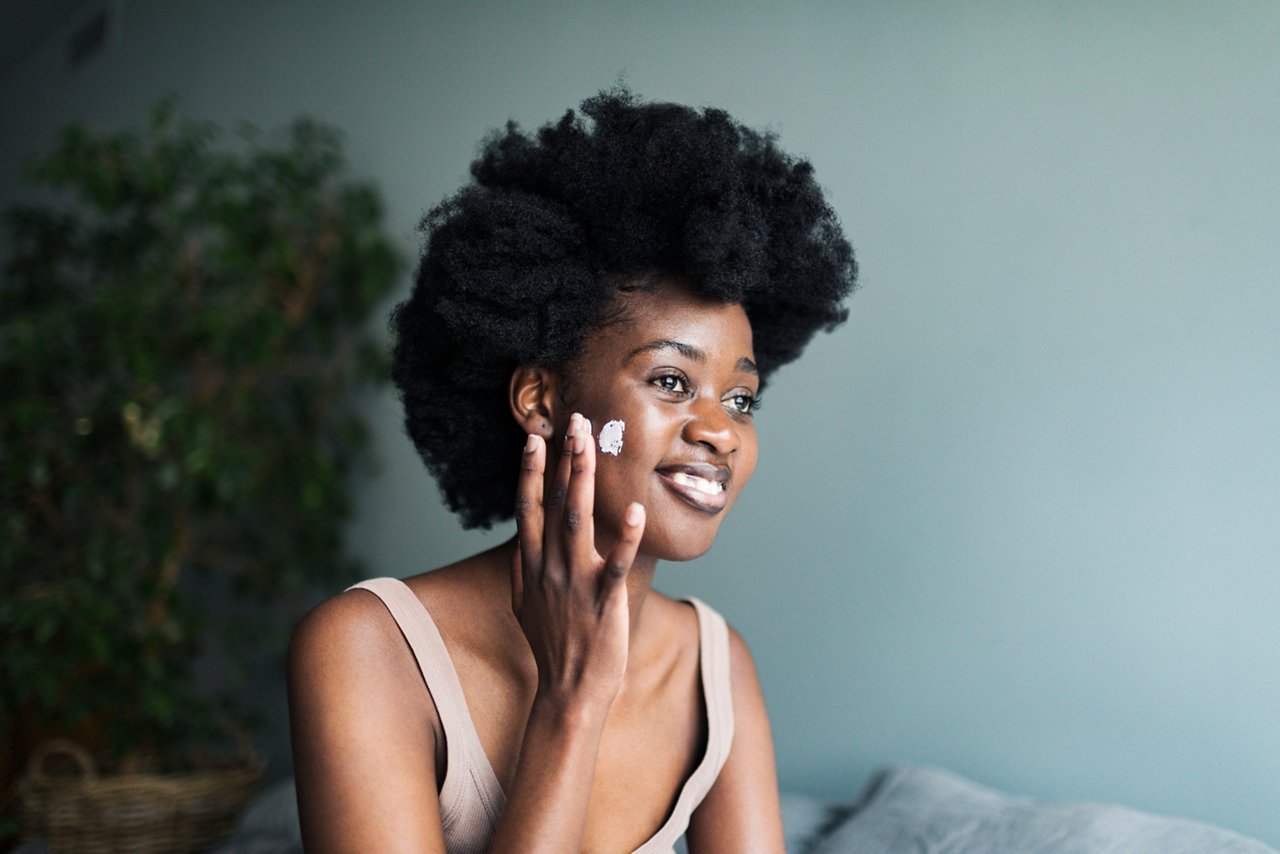 Woman applying facial cream