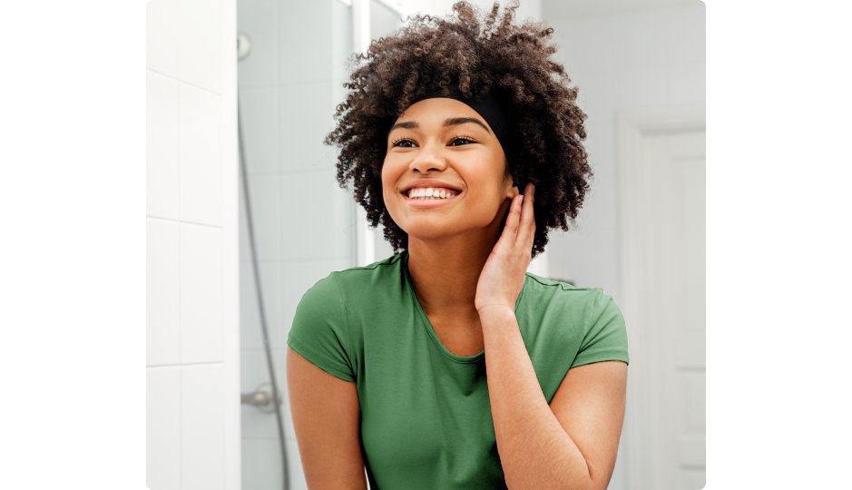 Woman checking her skin in the mirror
