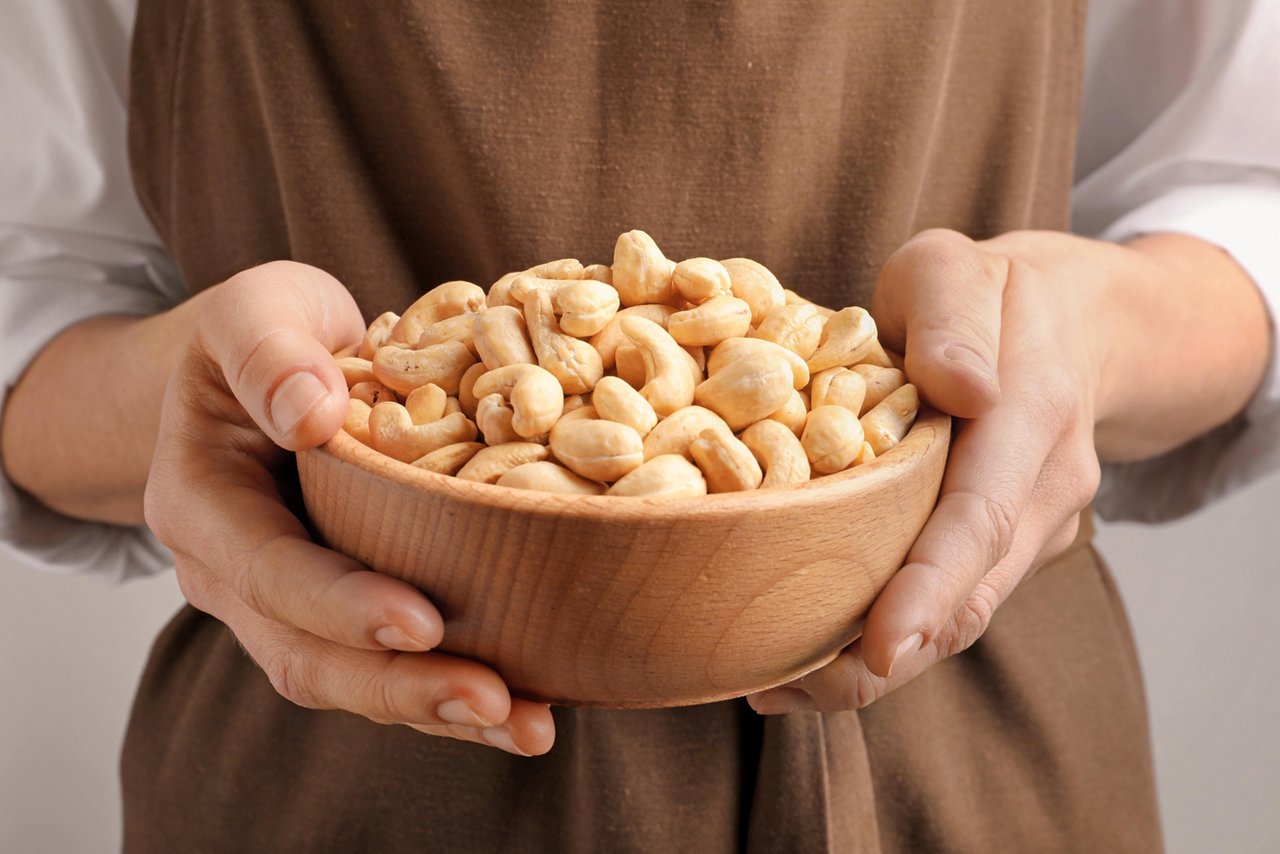 Woman holding bowl of nuts