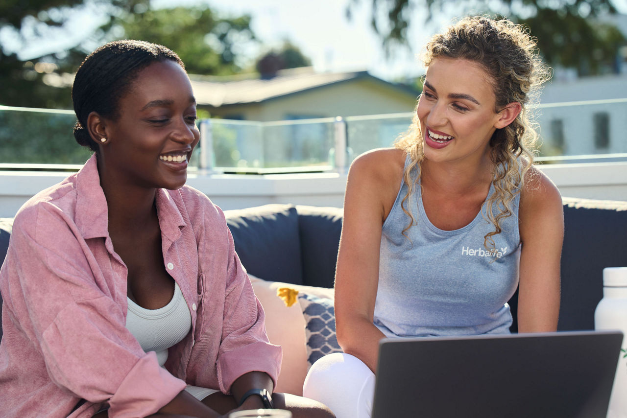 Two women working on a laptop