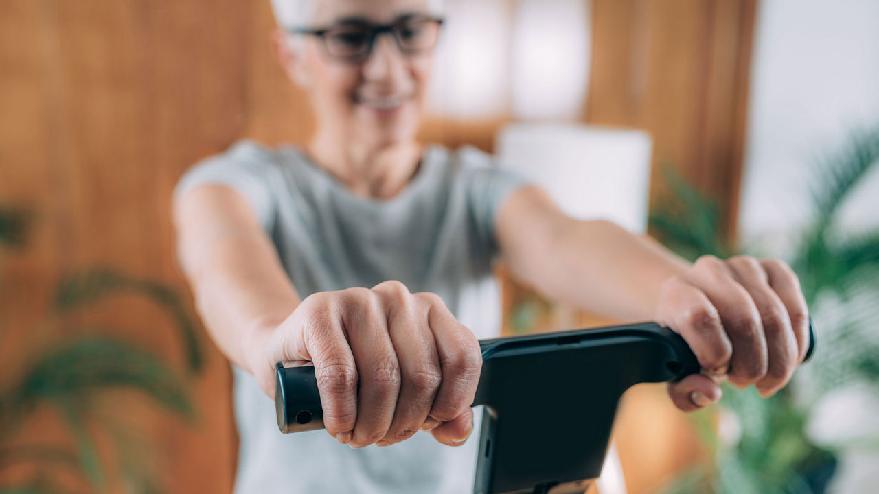 Cheerful Senior Woman Measuring Body Composition with Digital Scale Monitor at Home