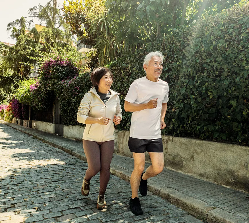 Old couple jogging outdoors