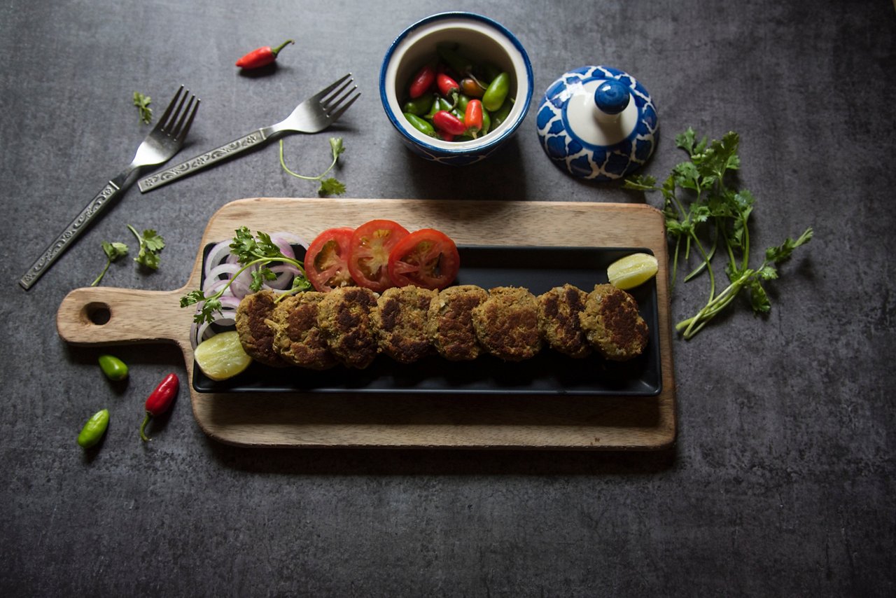 Top view of shami kebab on a tray, with use of selective focus on a particular part of one kebab, with rest of the kebab, the other kebabs, the tray and everything else blurred.; Shutterstock ID 2329341847; purchase_order: PO#1102059416; job: H1; client: Albert; other: GBS/Giselle