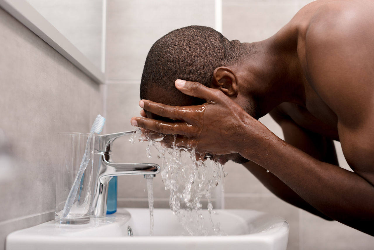 Man washing his face in the morning