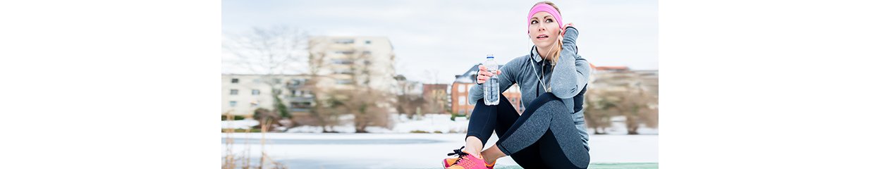 Woman resting from jogging or sport on winter day in the sun