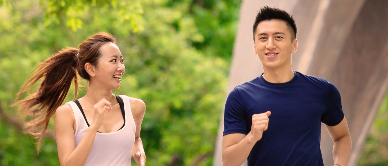 happy young Couple jogging and running  in park
