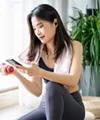 Woman exercising while checking her phone