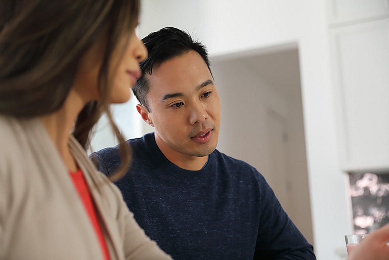 Woman pouring shake for man