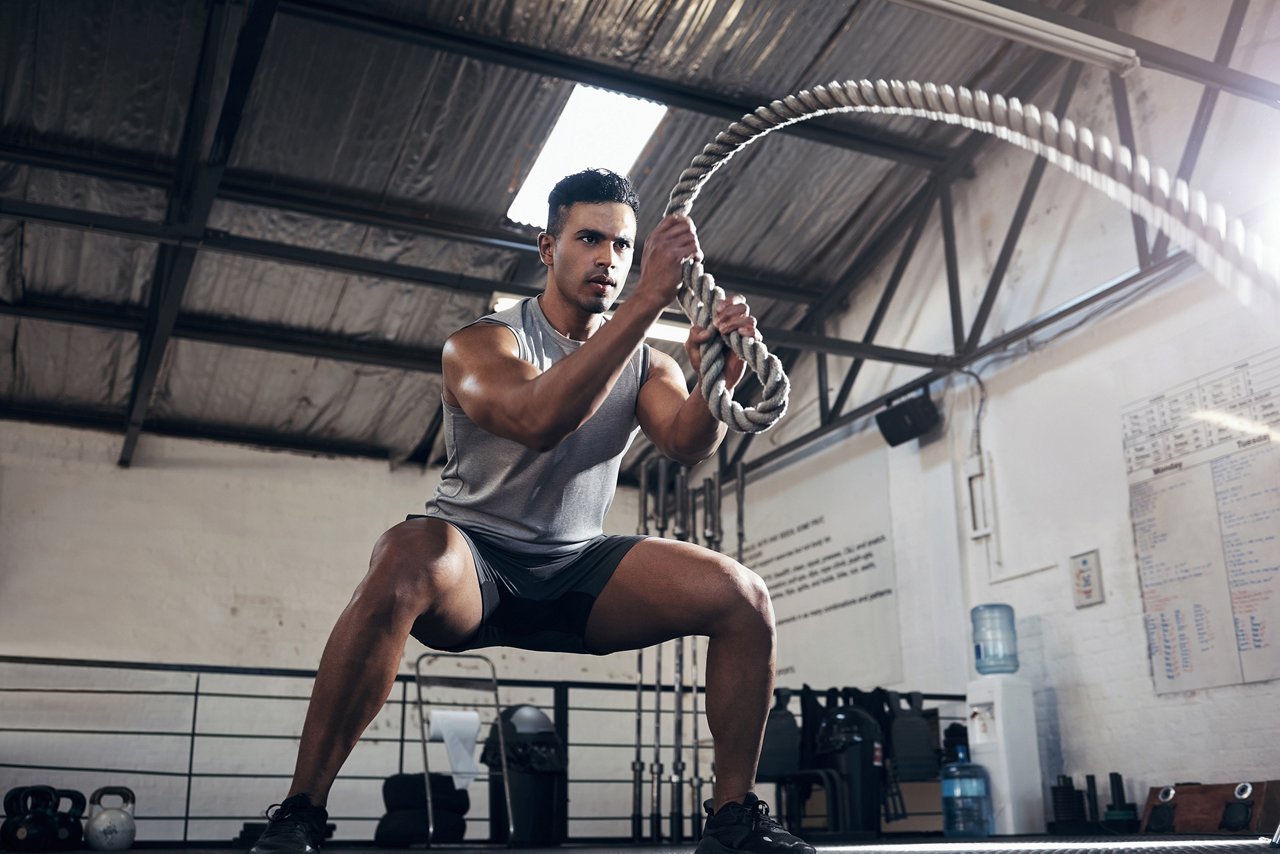 Man With Ropes Working Out In Gym