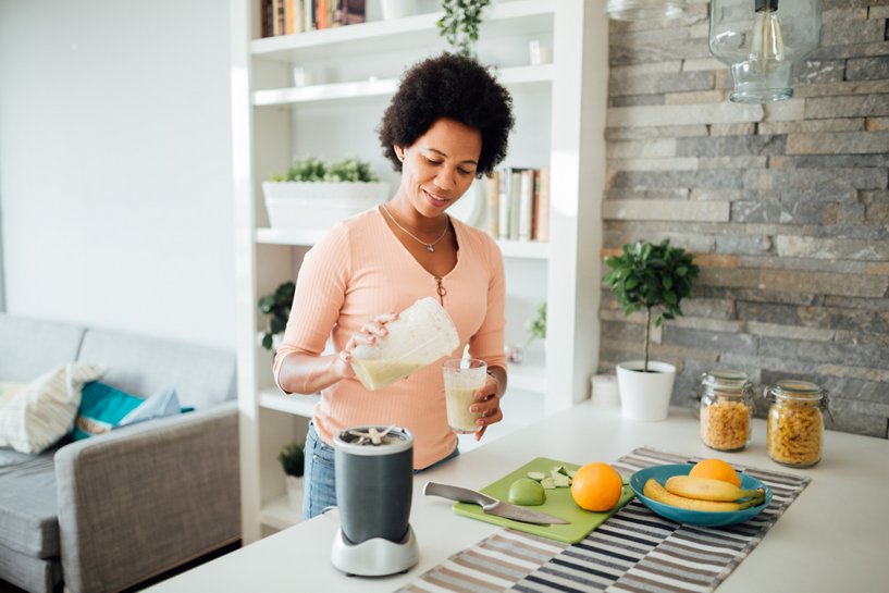 A woman enjoying a health shake as part of a nutritious diet.