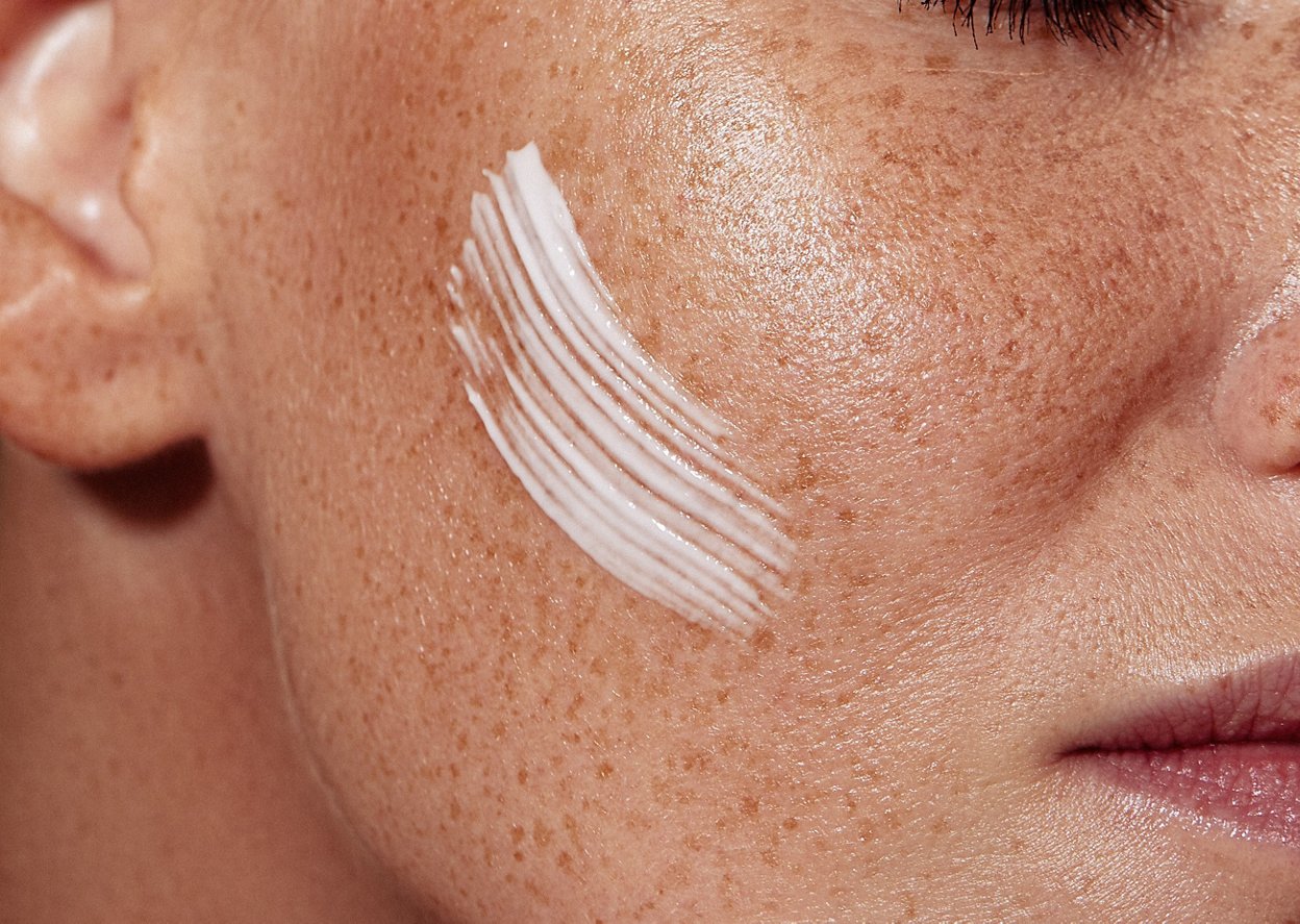 Woman applying suncream