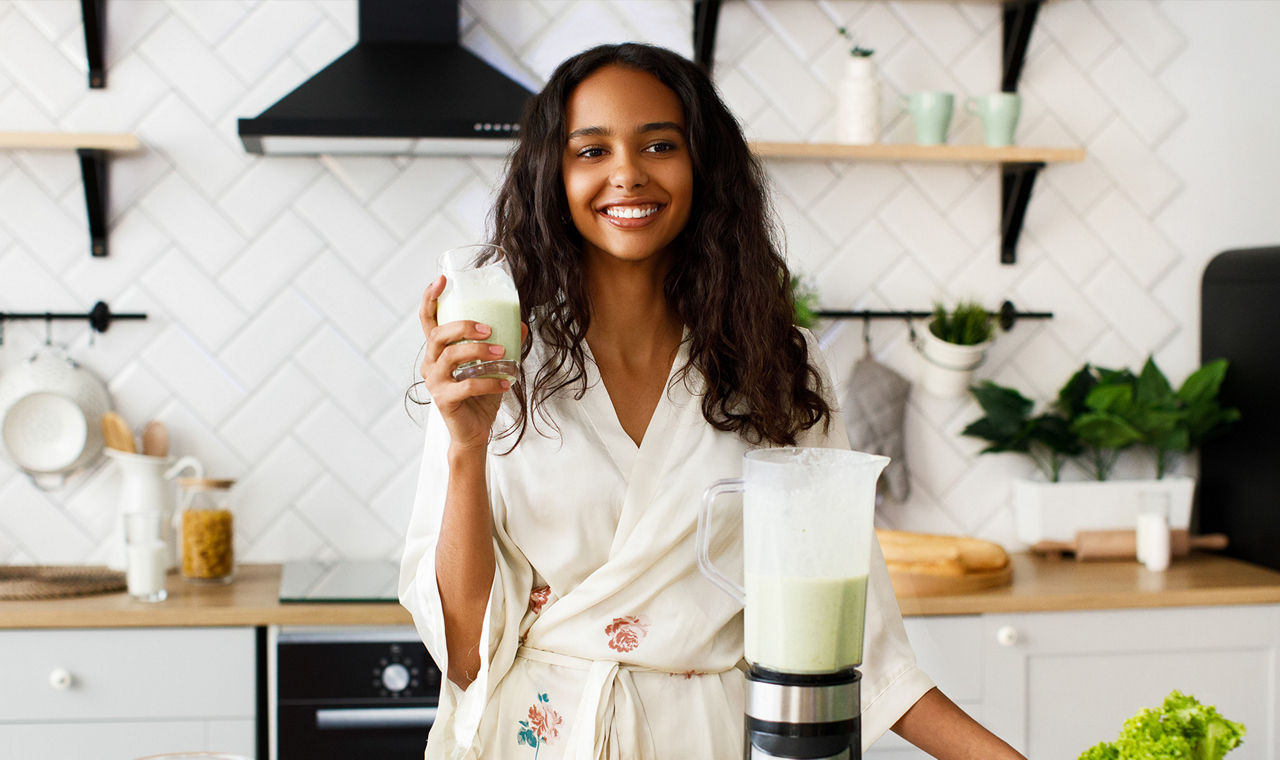 Woman adding protein powder shaker