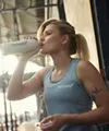 Woman Drinking Beverage Gym
