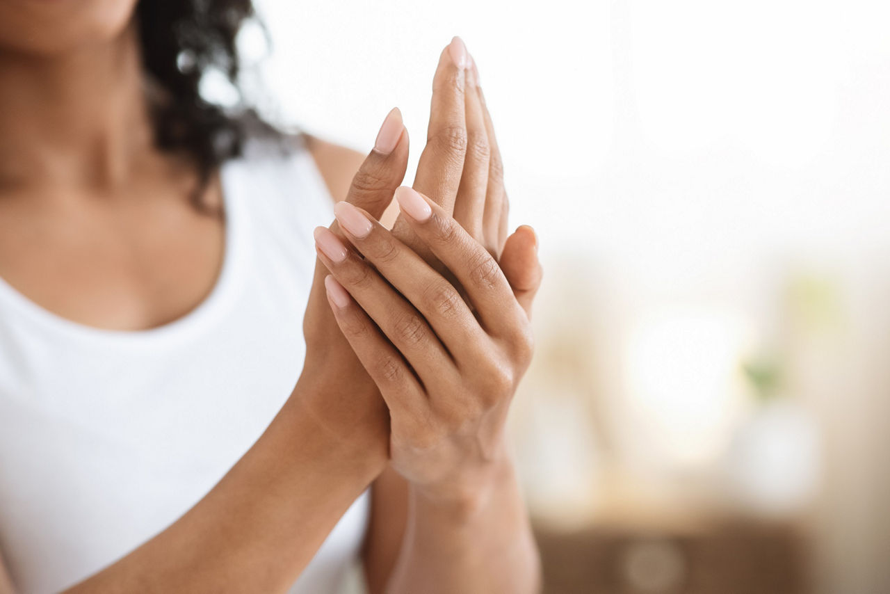 Woman putting a cream on her hands