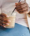 Woman holding protein shake in glass