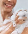Woman using body wash in the shower