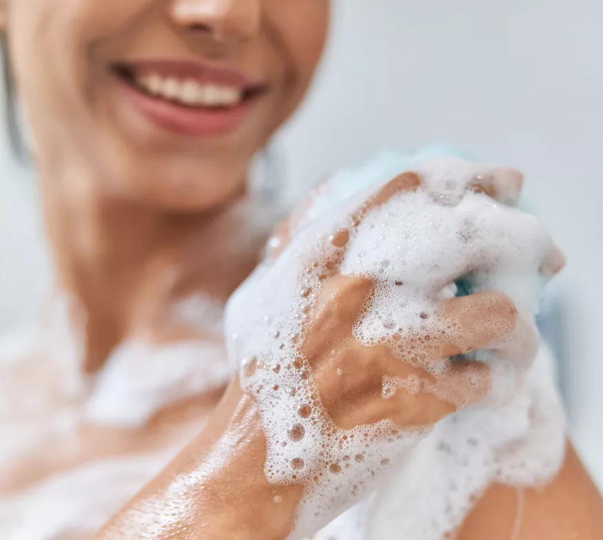 Woman using body wash in the shower