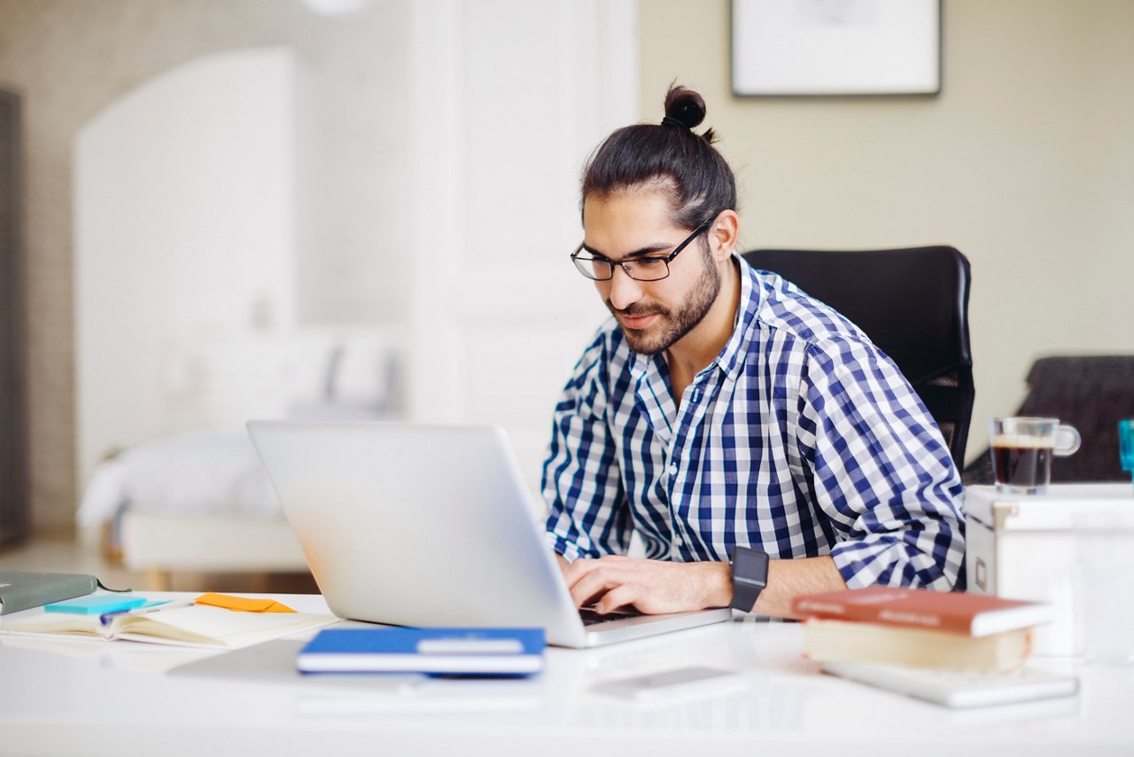 Young man working on a computer at home
