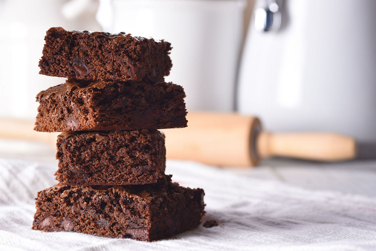 Closeup of a plate of fresh homemade brownies on a white towel 