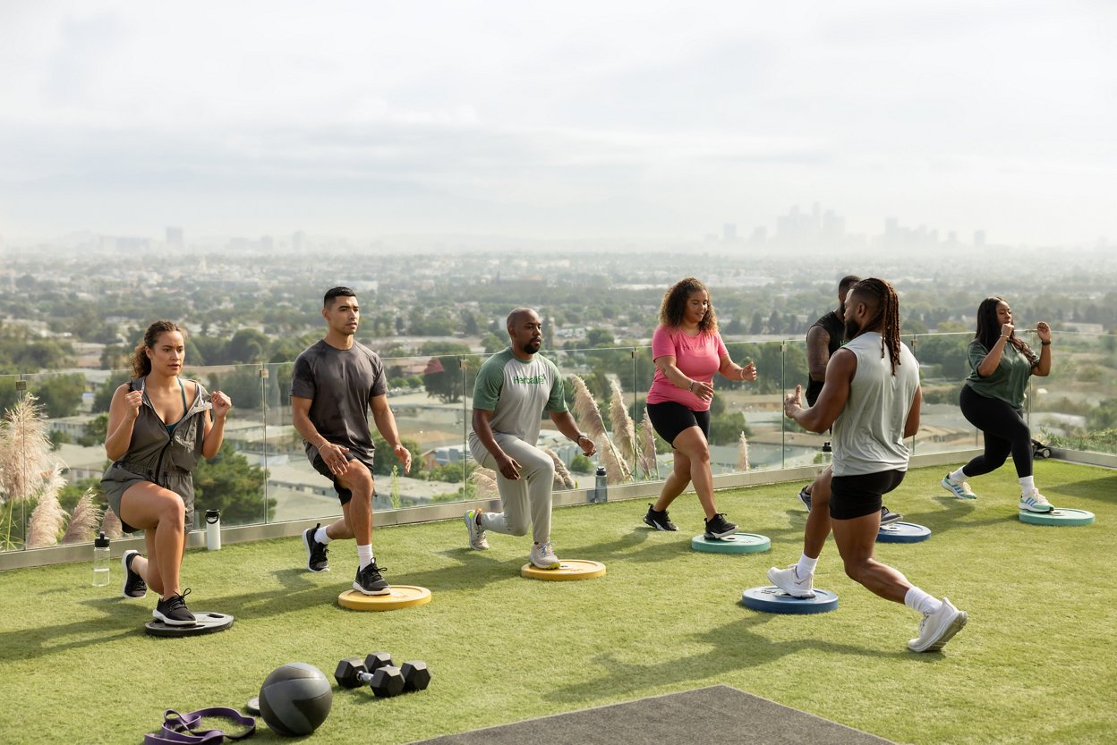 Large group of people exercising outdoors.