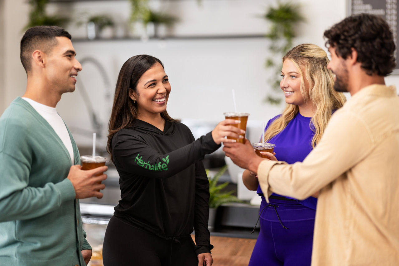 Distributor Handing Herbalife Tea to a Customer