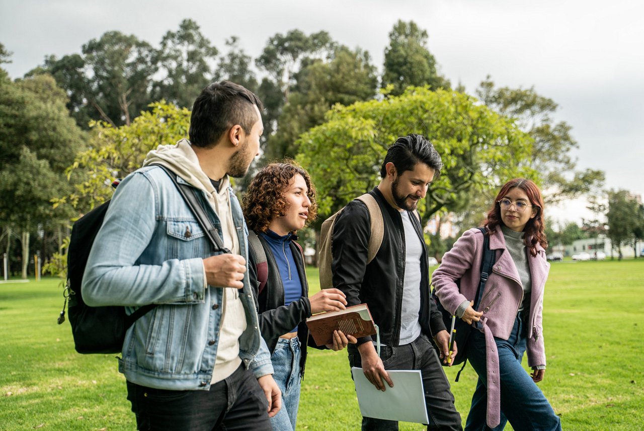 Student friends talking while walking through the university campus