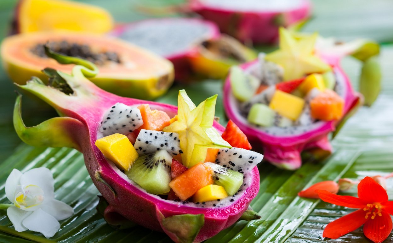 Exotic fruit salad served in half a dragon fruit