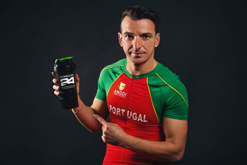 Fotografia de Lenine Cunha, atleta paralímpico e patrocinado pela Herbalife, segurando um shaker Herbalife24®