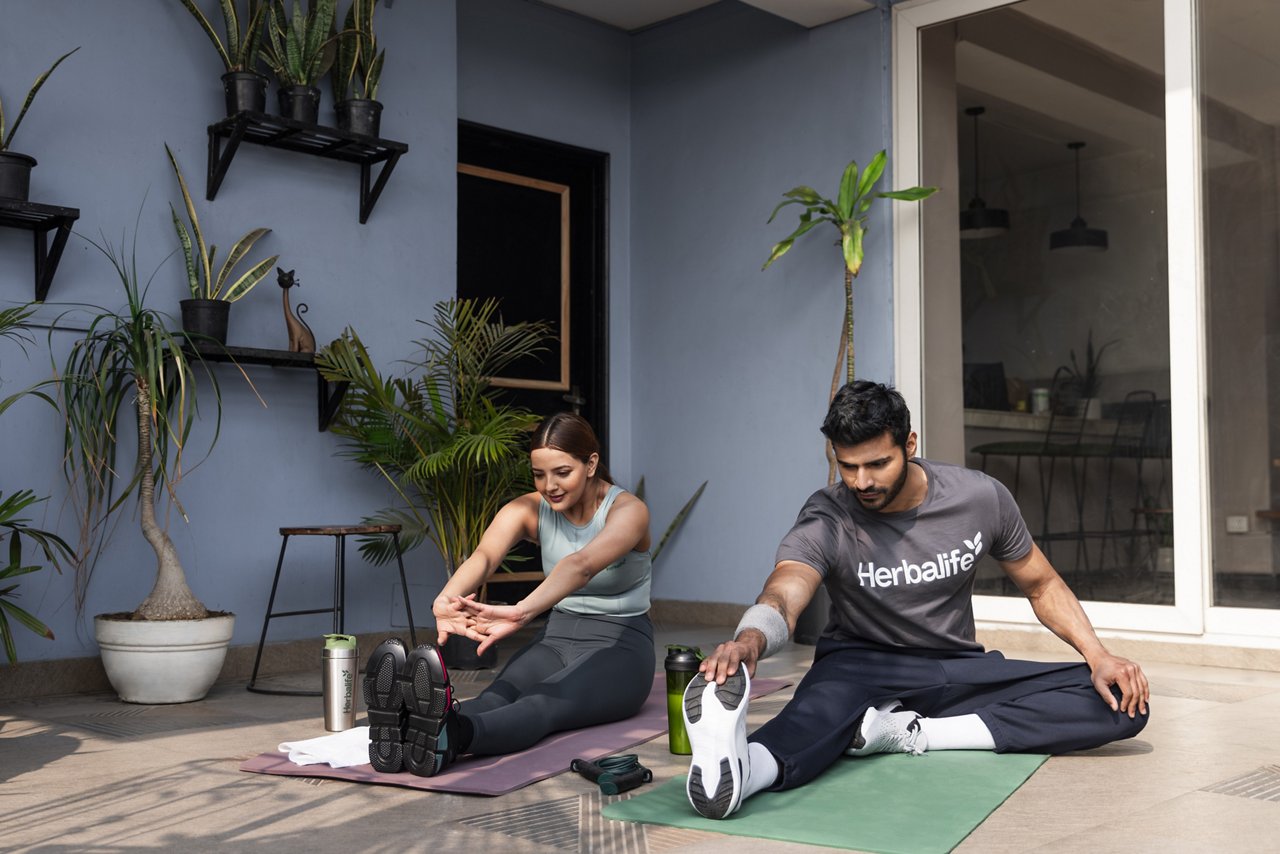 A couple doing stretches and warming up for a workout