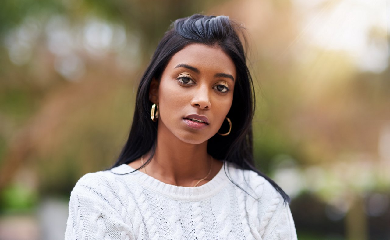 Cropped shot of a beautiful young woman standing outdoors.