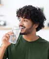 Happy man drinking a glass of water
