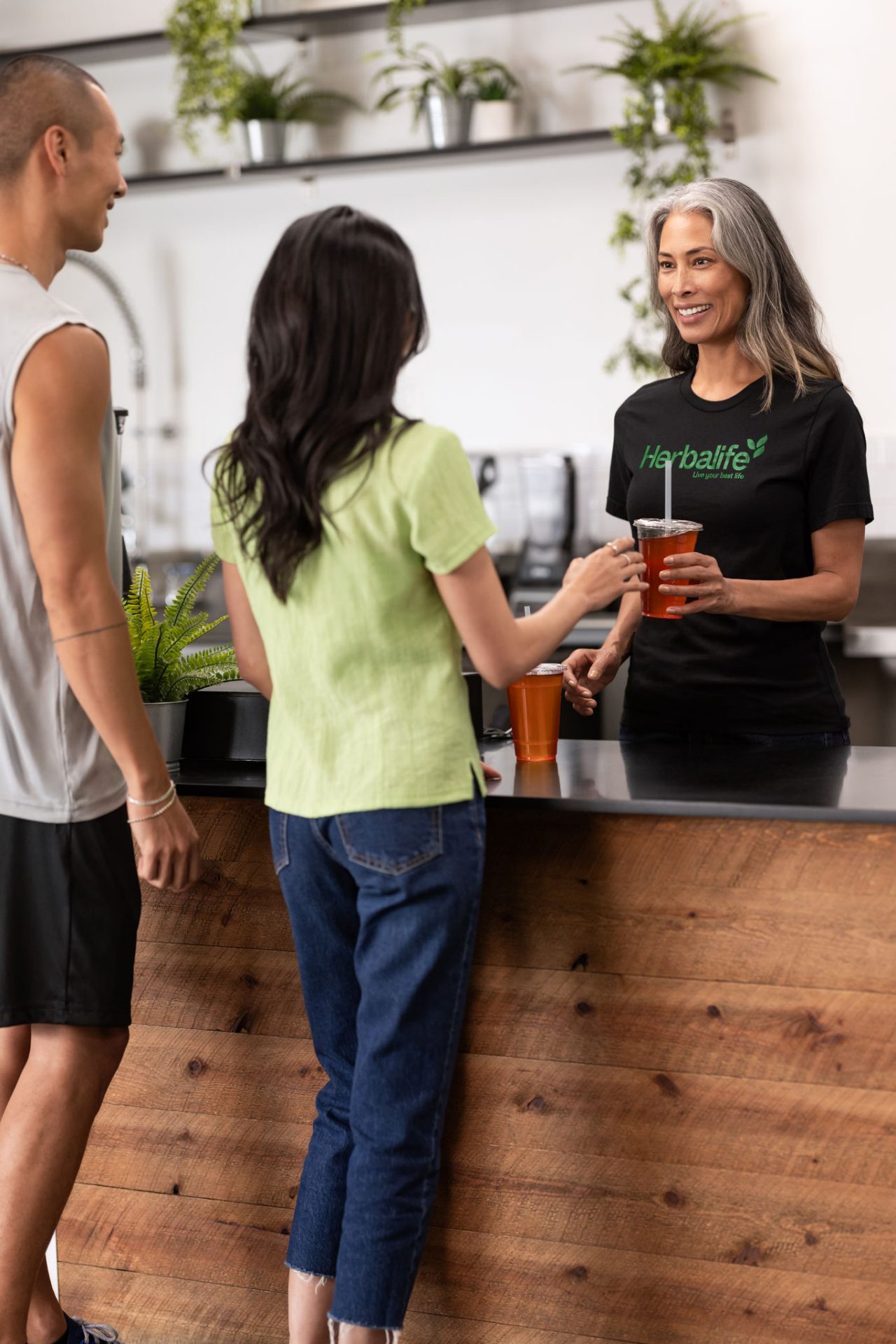 Woman gives tea to a friend.