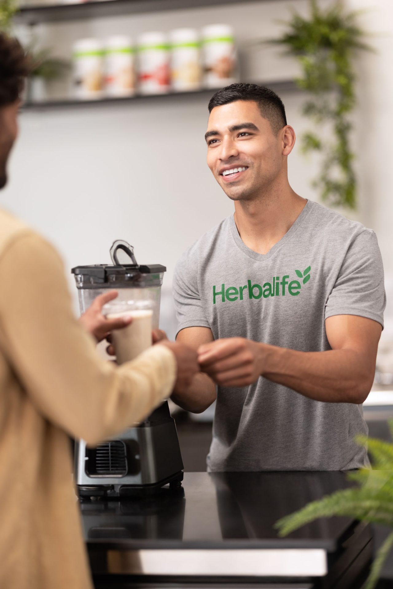 Man smiling when giving out a shake.